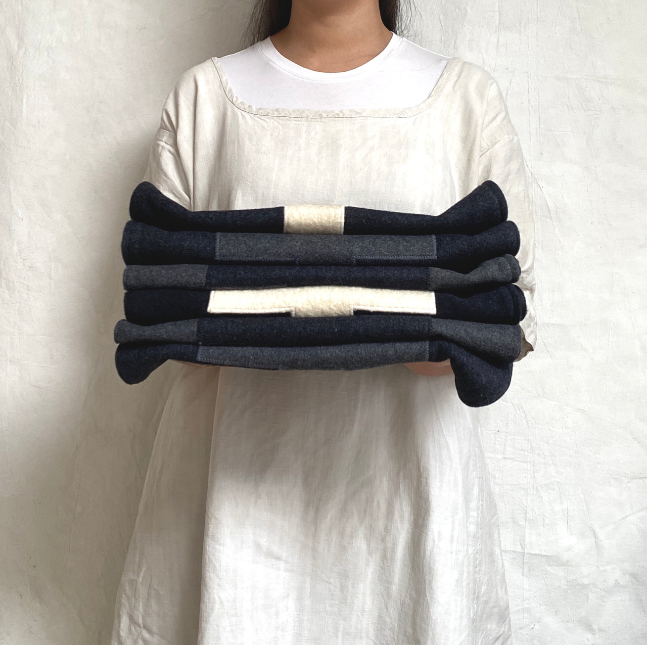 applique wool pillows. cream with black cross