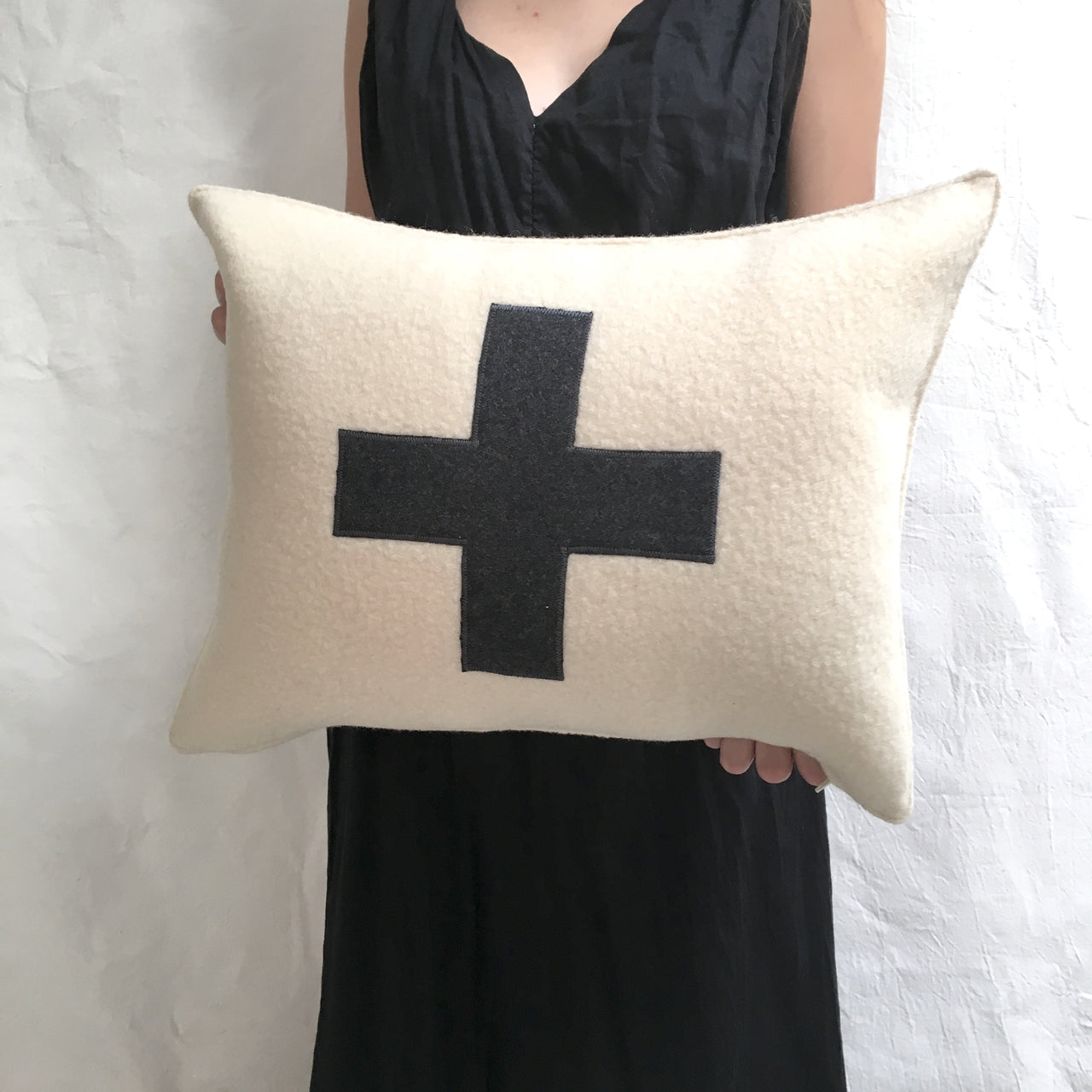 applique wool pillows. cream with black cross