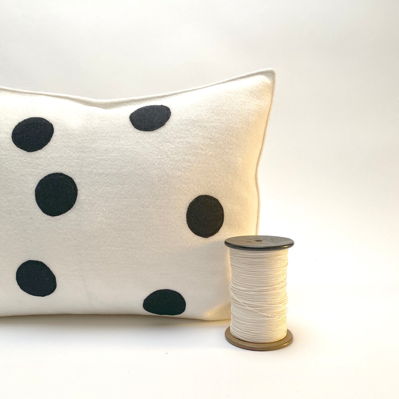 applique wool pillows. white and black dots